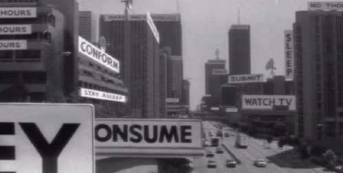 Gif du film « They live » en noir & blanc où les affiches publicitaires deviennent "conform", "consume", "watch", "submit", "sleep", etc